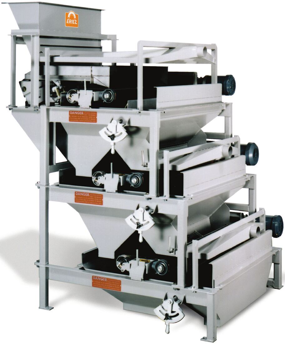 Eriez multi-stage rare earth roll separator on an open frame, the feed hopper above and the magnetic rolls and belts stacked in series below