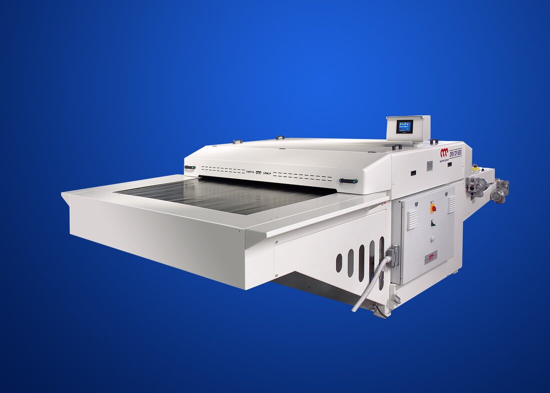 Martin Group Open Top fusing press with the heated head raised above a wide flat working plane and the loading table extended to the left