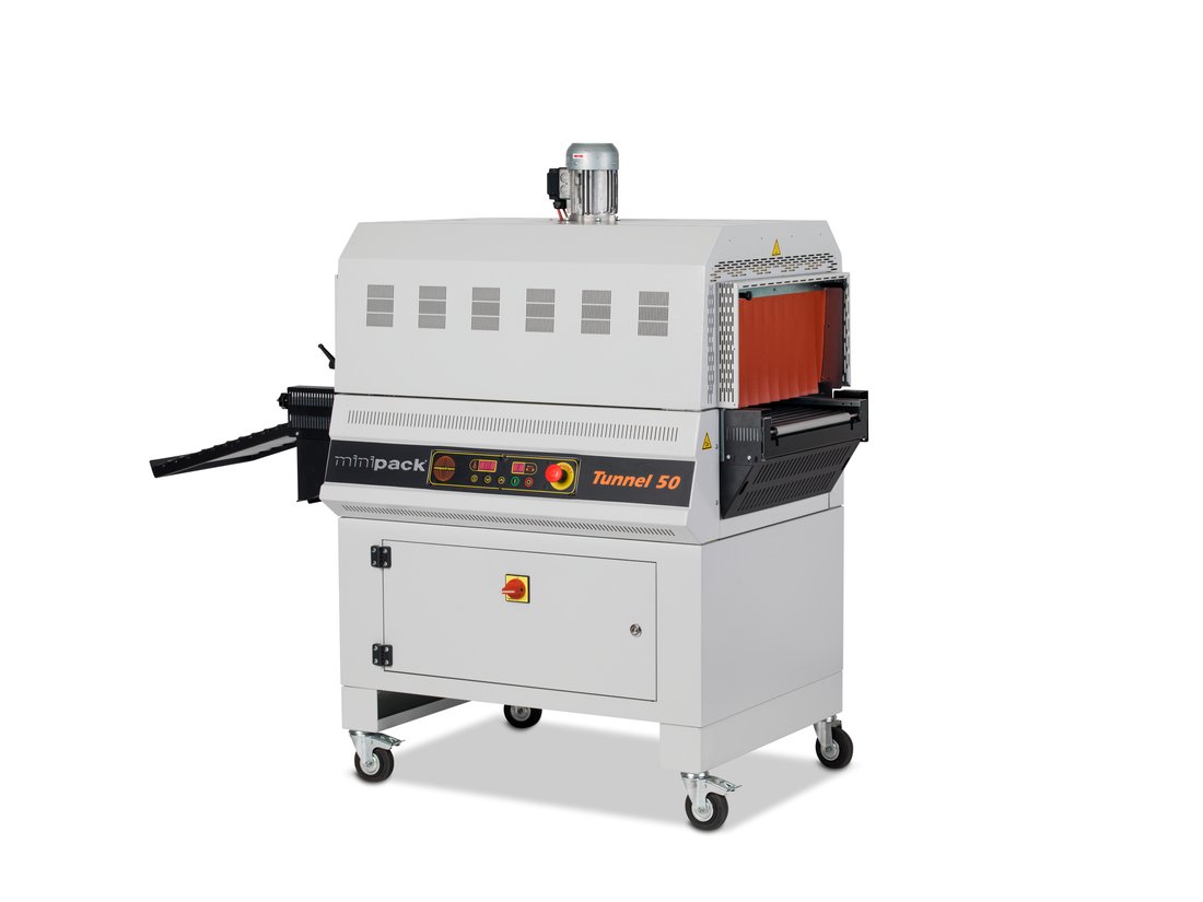 Minipack-Torre Tunnel 50 shrink tunnel on its cabinet base, running an open-weave PTFE mesh conveyor belt through the heated chamber
