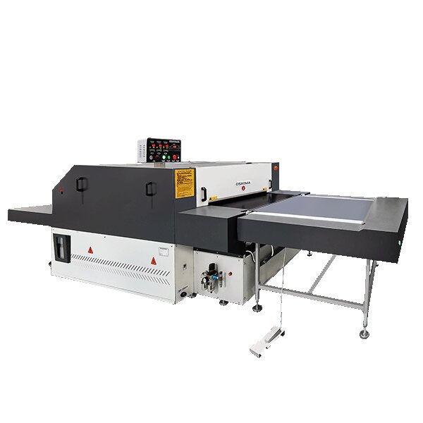 Oshima continuous fusing machine with a large heated section, control head on top and the belt outfeed table extended, OSHIMA badge on the housing