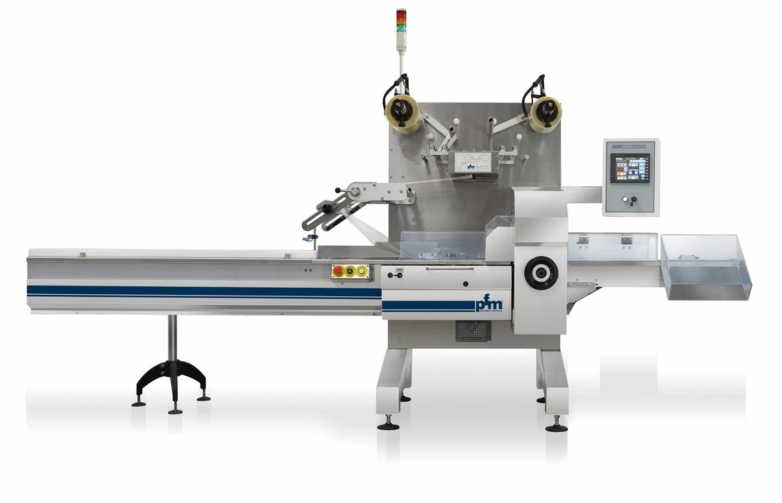 PFM Bora horizontal flow wrapper in stainless steel with the film reel mounted above the forming box