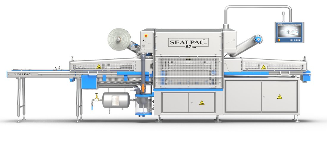 Sealpac A7max inline traysealer seen from the front, with the film reel and control monitor on the sealing station