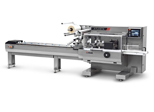 ULMA Atlanta horizontal flow wrapper with its long product infeed conveyor feeding the crimp jaws